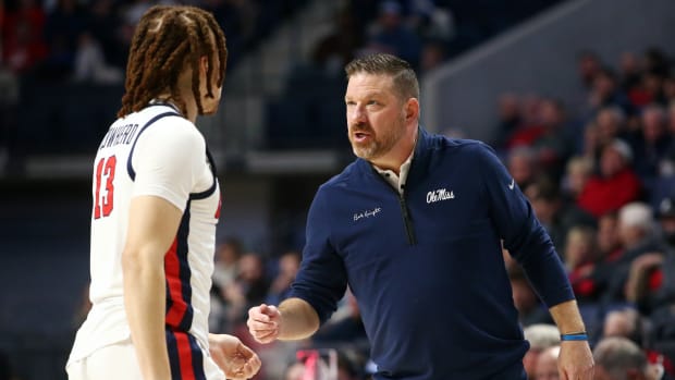 Ole Miss Rebels coach Chris Beard talking with forward Robert Cowherd (#13) versus the N.C. State Wolfpack (2023).